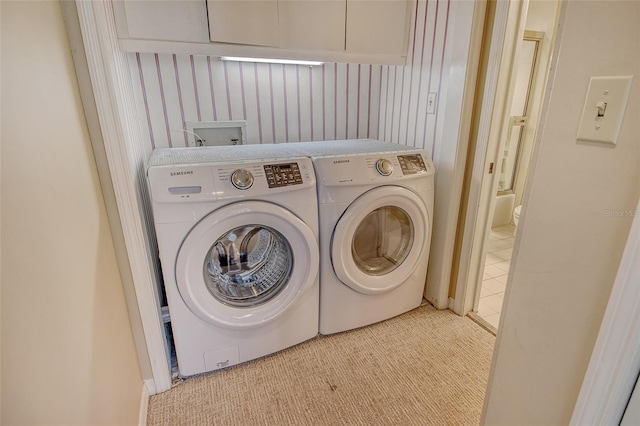 1211 Gulf Of Mexico Dr Unit 105, Longboat Key, FL 34228 - washroom with washer and clothes dryer and carpet floors