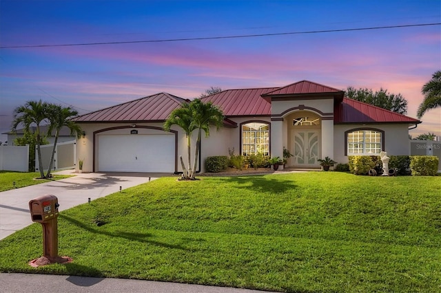 1402 SW 4th Ln, Cape Coral, FL 33991 - mediterranean / spanish-style house featuring stucco siding, concrete driveway, a metal roof, and a garage