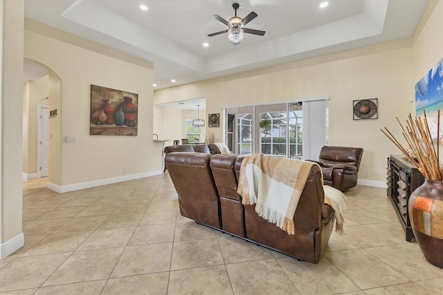 1402 SW 4th Ln, Cape Coral, FL 33991 - living area featuring a ceiling fan, light tile patterned flooring, arched walkways, a tray ceiling, and recessed lighting