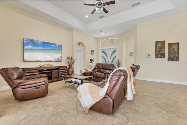 1402 SW 4th Ln, Cape Coral, FL 33991 - living room featuring light tile patterned flooring, ceiling fan, arched walkways, a raised ceiling, and recessed lighting