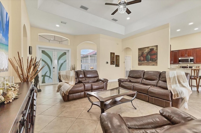 1402 SW 4th Ln, Cape Coral, FL 33991 - living area with arched walkways, ceiling fan, light tile patterned flooring, recessed lighting, and french doors
