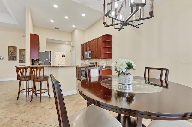 1402 SW 4th Ln, Cape Coral, FL 33991 - dining area featuring light tile patterned flooring, recessed lighting, a chandelier, and a towering ceiling