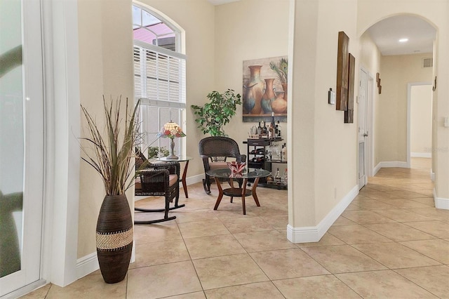1402 SW 4th Ln, Cape Coral, FL 33991 - hallway featuring arched walkways and light tile patterned flooring