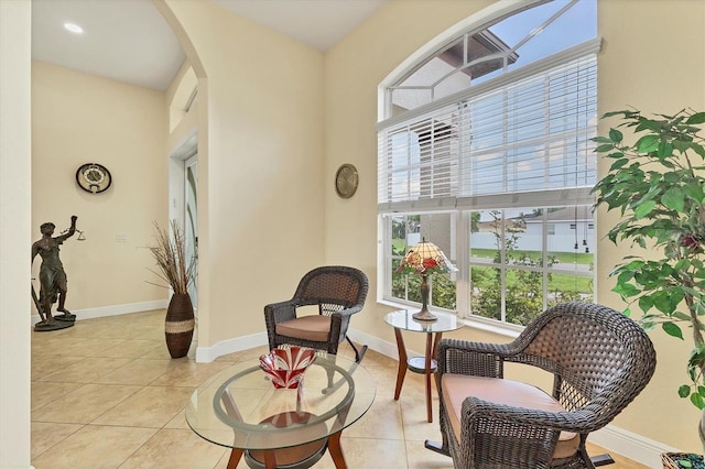 1402 SW 4th Ln, Cape Coral, FL 33991 - sitting room featuring healthy amount of natural light, light tile patterned floors, and arched walkways