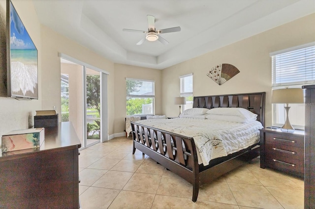 1402 SW 4th Ln, Cape Coral, FL 33991 - bedroom with light tile patterned floors, a raised ceiling, and a ceiling fan