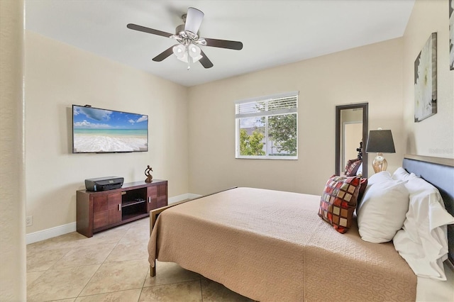 1402 SW 4th Ln, Cape Coral, FL 33991 - bedroom with light tile patterned flooring and a ceiling fan