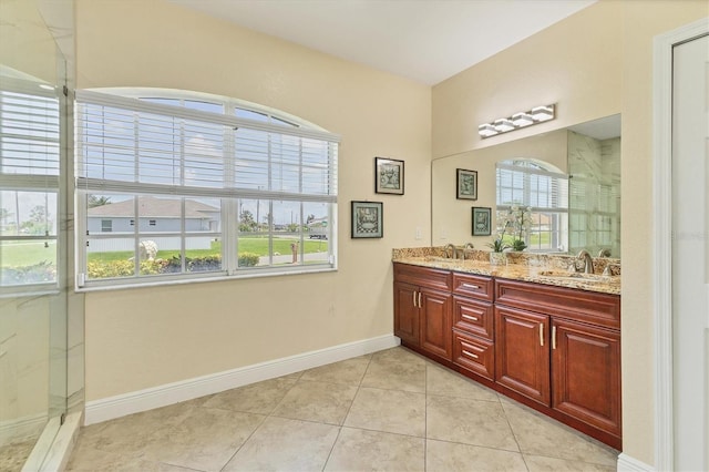 1402 SW 4th Ln, Cape Coral, FL 33991 - bathroom with a marble finish shower, double vanity, and tile patterned flooring
