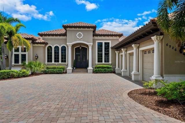 6926 Lacantera Cir, Lakewood Ranch, FL 34202 - view of front of property featuring decorative driveway, an attached garage, a tiled roof, and stucco siding