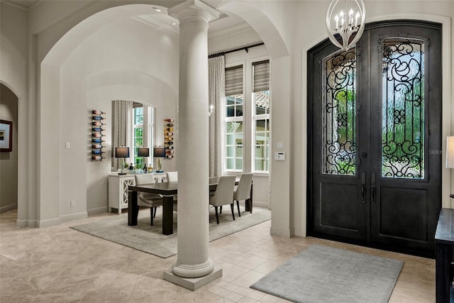 6926 Lacantera Cir, Lakewood Ranch, FL 34202 - entrance foyer with ornamental molding, arched walkways, a chandelier, and french doors