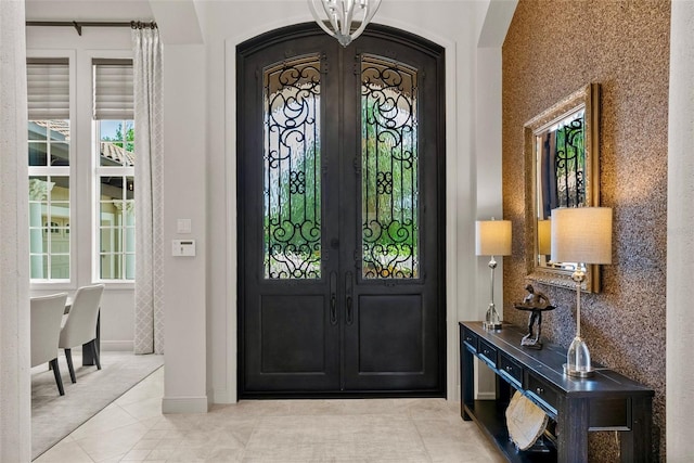 6926 Lacantera Cir, Lakewood Ranch, FL 34202 - foyer entrance with plenty of natural light, light tile patterned flooring, and arched walkways