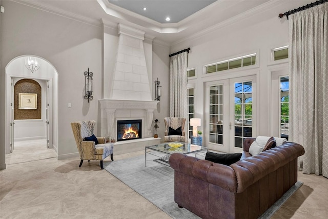 6926 Lacantera Cir, Lakewood Ranch, FL 34202 - living room with french doors, crown molding, a fireplace, a high ceiling, and recessed lighting