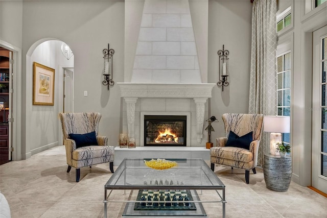 6926 Lacantera Cir, Lakewood Ranch, FL 34202 - living area with a fireplace, plenty of natural light, and arched walkways