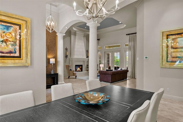 6926 Lacantera Cir, Lakewood Ranch, FL 34202 - dining room with ornate columns, a chandelier, a fireplace, crown molding, and arched walkways