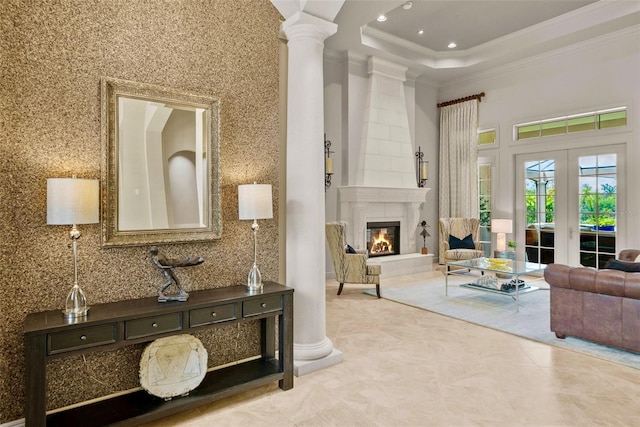 6926 Lacantera Cir, Lakewood Ranch, FL 34202 - living area featuring decorative columns, ornamental molding, tile patterned flooring, a towering ceiling, and a large fireplace