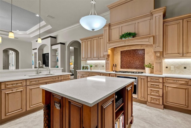 6926 Lacantera Cir, Lakewood Ranch, FL 34202 - kitchen featuring arched walkways, appliances with stainless steel finishes, crown molding, a center island, and hanging light fixtures