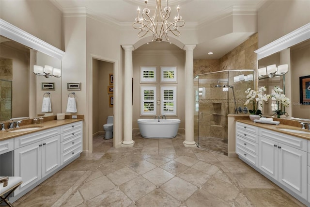 6926 Lacantera Cir, Lakewood Ranch, FL 34202 - full bathroom with ornate columns, a shower stall, two vanities, crown molding, and a soaking tub