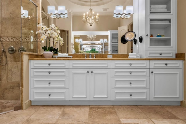 6926 Lacantera Cir, Lakewood Ranch, FL 34202 - full bathroom with a chandelier, double vanity, tiled shower, stone tile flooring, and crown molding