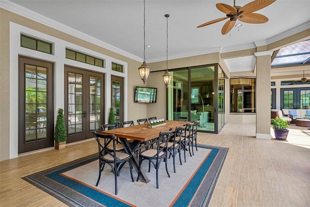 6926 Lacantera Cir, Lakewood Ranch, FL 34202 - dining room with french doors, ceiling fan, wood finished floors, and crown molding
