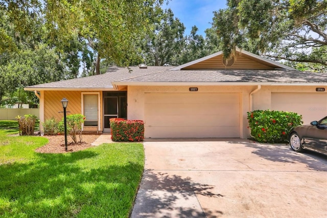3557 Wilkinson Woods Dr, Sarasota, FL 34231 - ranch-style house featuring a garage, a front lawn, concrete driveway, stucco siding, and a shingled roof