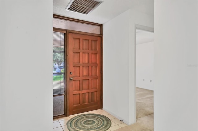 3557 Wilkinson Woods Dr, Sarasota, FL 34231 - foyer entrance with light tile patterned floors and light carpet