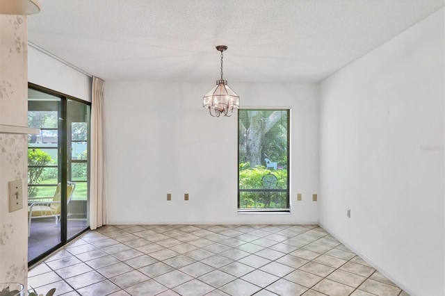 3557 Wilkinson Woods Dr, Sarasota, FL 34231 - empty room with plenty of natural light, a chandelier, a textured ceiling, and light tile patterned floors