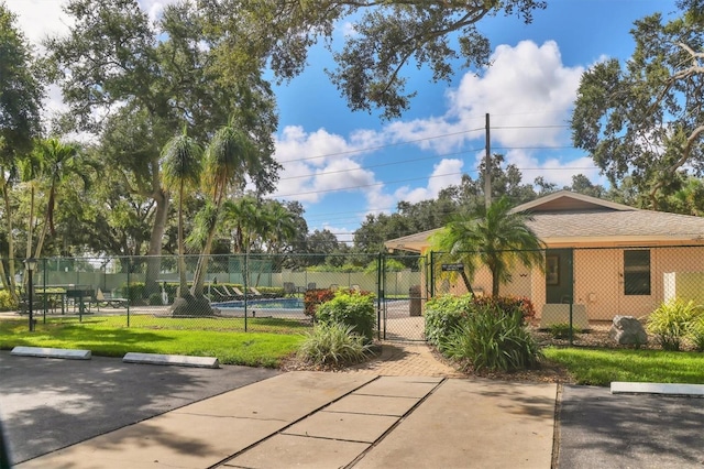 3557 Wilkinson Woods Dr, Sarasota, FL 34231 - view of property's community featuring uncovered parking, a pool, and a gate