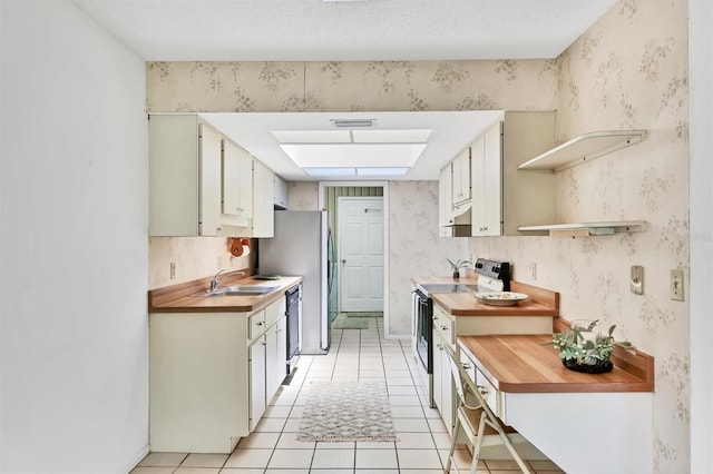 3557 Wilkinson Woods Dr, Sarasota, FL 34231 - kitchen with electric stove, black dishwasher, light tile patterned floors, butcher block countertops, and under cabinet range hood