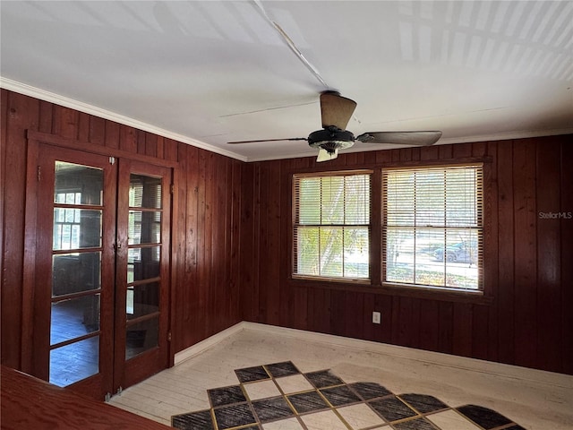 1109 Patterson Dr, Sarasota, FL 34234 - empty room with french doors, wood walls, ceiling fan, and crown molding