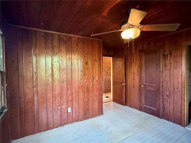 1109 Patterson Dr, Sarasota, FL 34234 - unfurnished room featuring wooden walls, wood ceiling, ceiling fan, and wood-type flooring