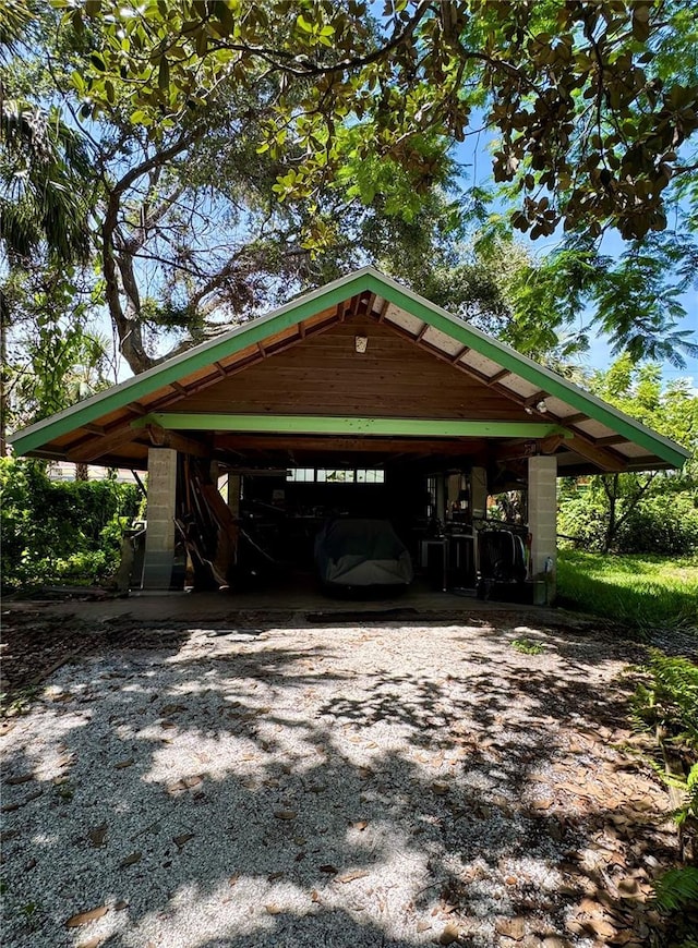 1109 Patterson Dr, Sarasota, FL 34234 - view of parking featuring driveway and a carport