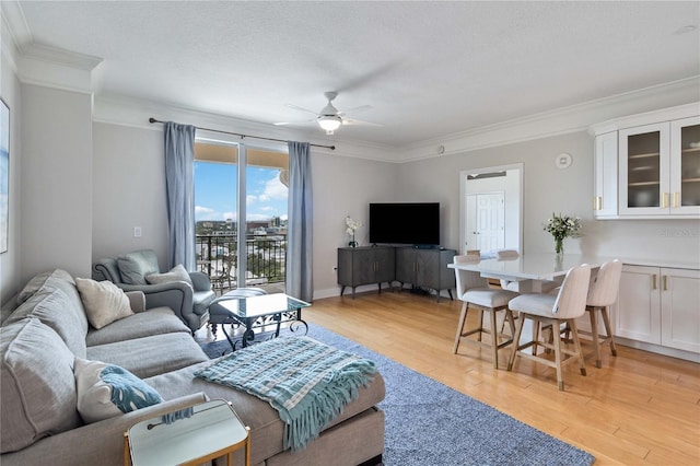 750 N Tamiami Trl Unit 1616, Sarasota, FL 34236 - living room with ceiling fan, crown molding, and light wood-style flooring