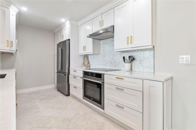 750 N Tamiami Trl Unit 1616, Sarasota, FL 34236 - kitchen featuring appliances with stainless steel finishes, under cabinet range hood, light countertops, decorative backsplash, and white cabinets