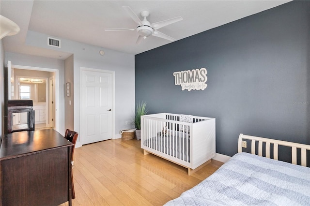 750 N Tamiami Trl Unit 1616, Sarasota, FL 34236 - bedroom featuring wood finished floors, a ceiling fan, and a desk