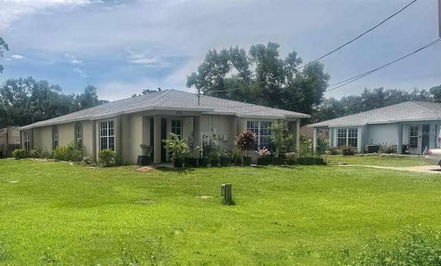 803 E Shell Point Rd, Ruskin, FL 33570 - rear view of property with a yard and stucco siding