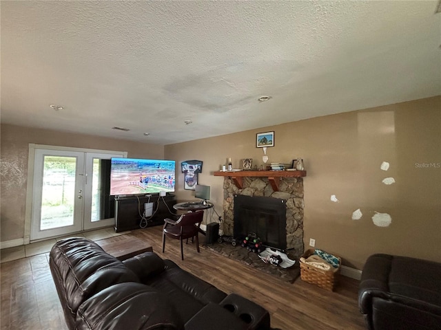 12345 Terra Ceia Ave, New Port Richey, FL 34654 - living area featuring wood finished floors, a fireplace, and a textured ceiling
