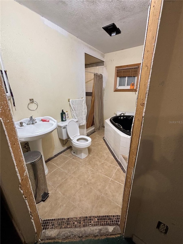 12345 Terra Ceia Ave, New Port Richey, FL 34654 - bathroom featuring a textured ceiling, a relaxing tiled tub, tile patterned flooring, and a shower with shower curtain