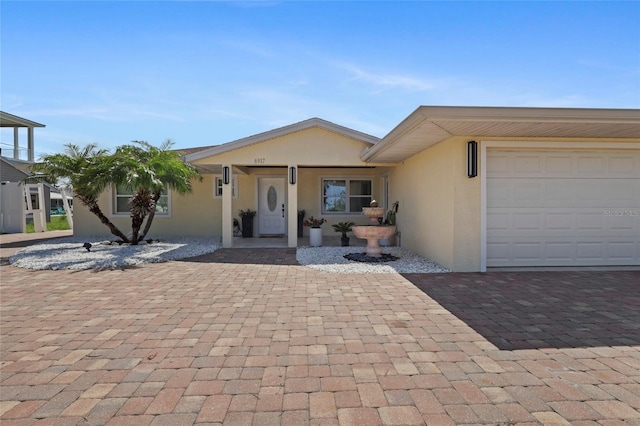 6917 22nd St W, Bradenton, FL 34207 - view of front of home featuring stucco siding and decorative driveway