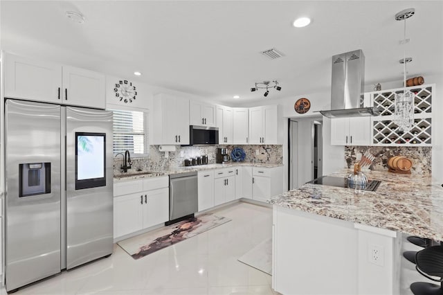 6917 22nd St W, Bradenton, FL 34207 - kitchen featuring appliances with stainless steel finishes, island exhaust hood, white cabinets, recessed lighting, and light stone countertops