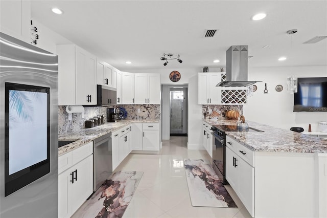 6917 22nd St W, Bradenton, FL 34207 - kitchen with appliances with stainless steel finishes, island exhaust hood, backsplash, white cabinetry, and recessed lighting