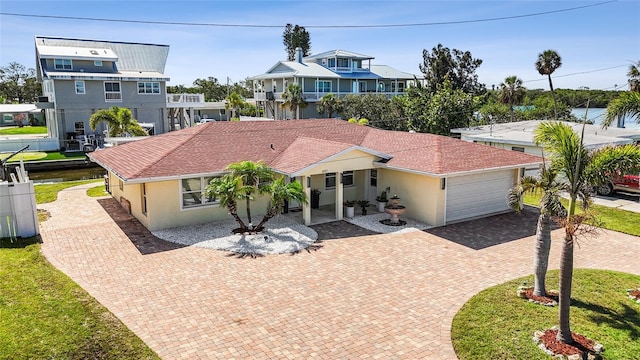 6917 22nd St W, Bradenton, FL 34207 - view of front facade with decorative driveway, an attached garage, stucco siding, and a residential view