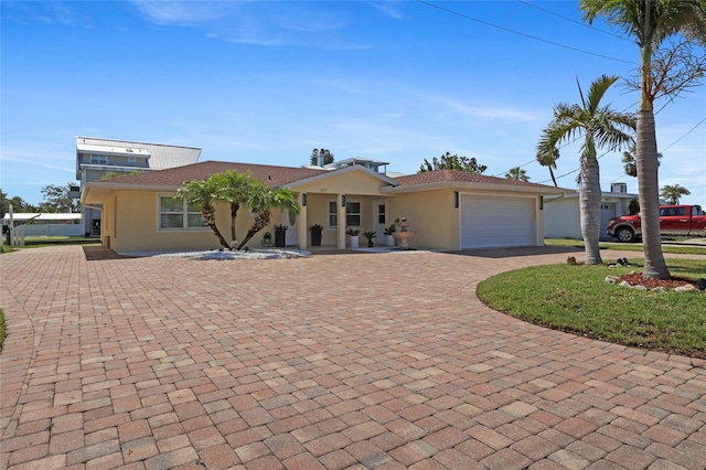 6917 22nd St W, Bradenton, FL 34207 - ranch-style home with curved driveway, stucco siding, and a garage
