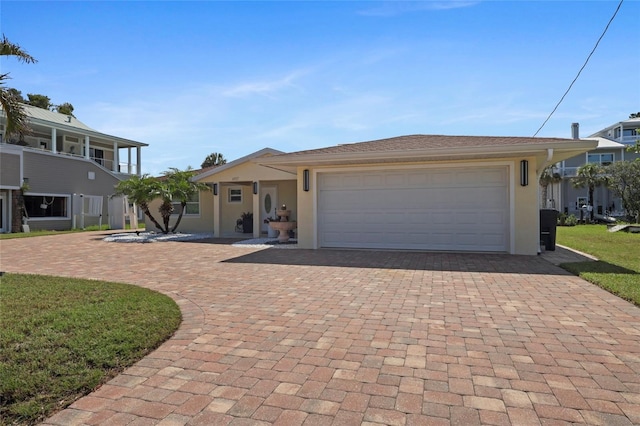6917 22nd St W, Bradenton, FL 34207 - view of front facade featuring decorative driveway, stucco siding, and a garage