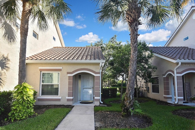 7605 Sweetbay Cir Unit 5-102, Bradenton, FL 34203 - view of exterior entry featuring stucco siding and a tiled roof