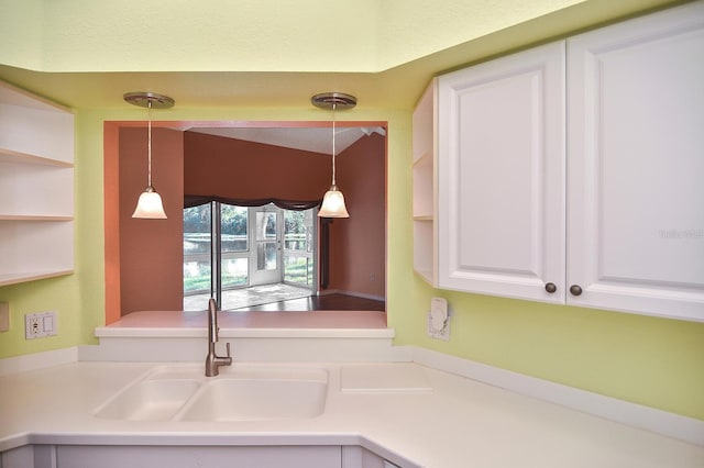 7605 Sweetbay Cir Unit 5-102, Bradenton, FL 34203 - kitchen featuring white cabinetry, decorative light fixtures, and light countertops