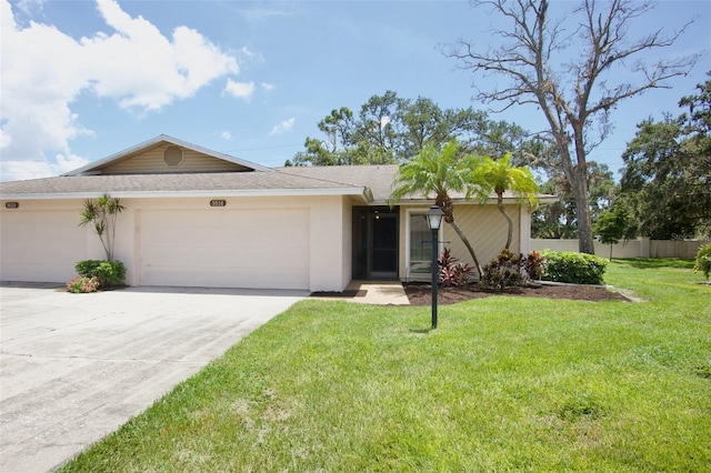3518 Wilkinson Woods Dr Unit 11, Sarasota, FL 34231 - ranch-style home with stucco siding, a garage, driveway, and roof with shingles