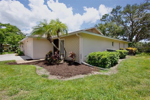 3518 Wilkinson Woods Dr Unit 11, Sarasota, FL 34231 - view of side of property featuring stucco siding, a garage, and a lawn