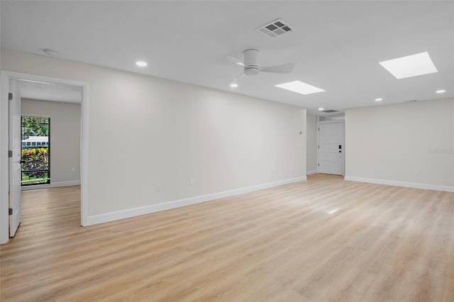 3518 Wilkinson Woods Dr Unit 11, Sarasota, FL 34231 - empty room with a skylight, light wood finished floors, recessed lighting, and a smoke detector