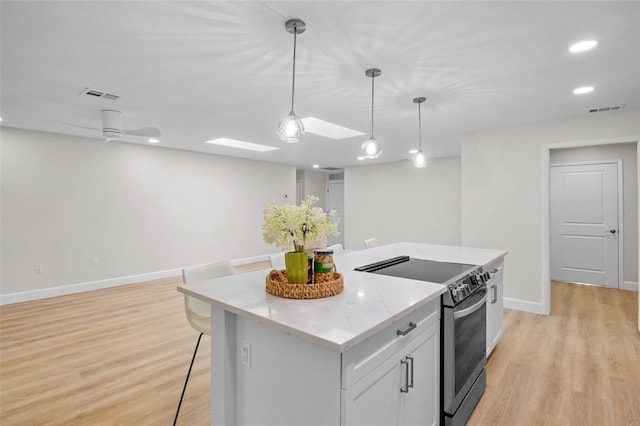 3518 Wilkinson Woods Dr Unit 11, Sarasota, FL 34231 - kitchen with stainless steel electric range, a center island, light wood finished floors, pendant lighting, and recessed lighting