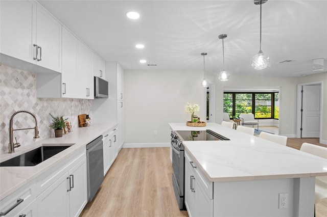 3518 Wilkinson Woods Dr Unit 11, Sarasota, FL 34231 - kitchen featuring stainless steel appliances, tasteful backsplash, light wood-style floors, light stone countertops, and recessed lighting