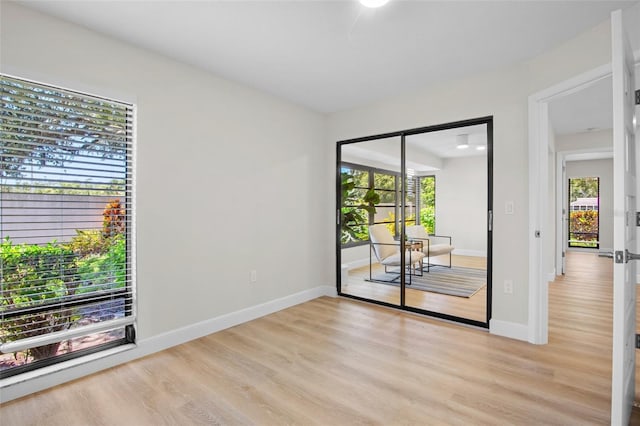 3518 Wilkinson Woods Dr Unit 11, Sarasota, FL 34231 - empty room with light wood-type flooring and plenty of natural light